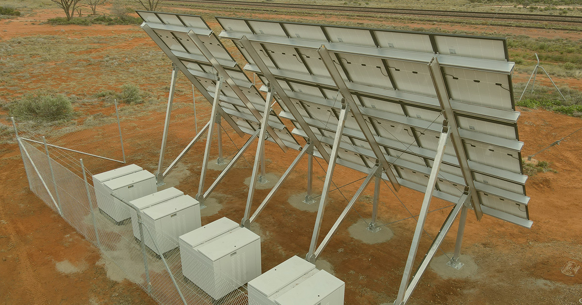 Solar panels installed on a fence in a remote area for an off grid solar hybrid power system at an Australian rail telecommunications project.