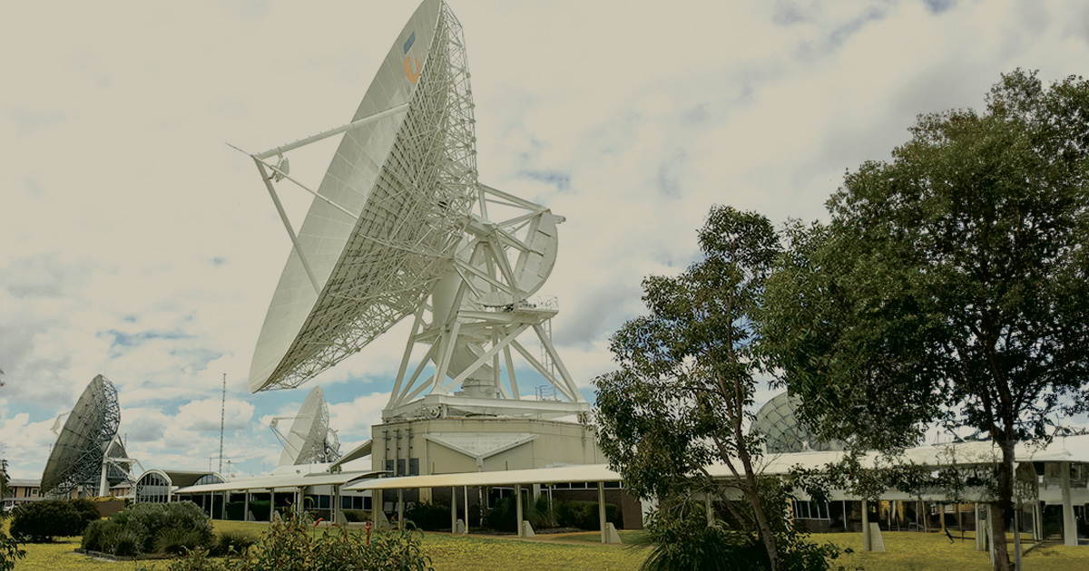 Satellite dish in a grassy area at PITC data centre site, supporting critical power systems infrastructure