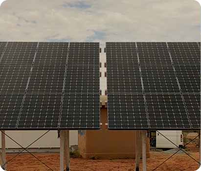 Two solar panels installed in a dirt field at PITC Gnangara as part of an off-grid solar hybrid energy system