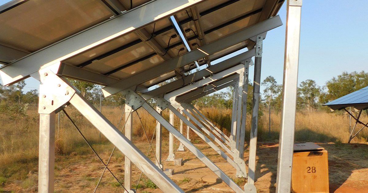 Solar panel array on a metal frame in a field supporting off grid power systems across SA, WA and NT.