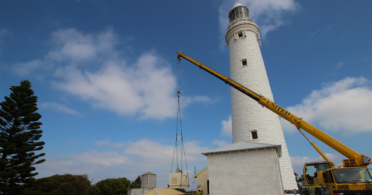 Hiab crane truck lifting a generator at Rottnest Island Lighthouse for backup power systems installation and support.