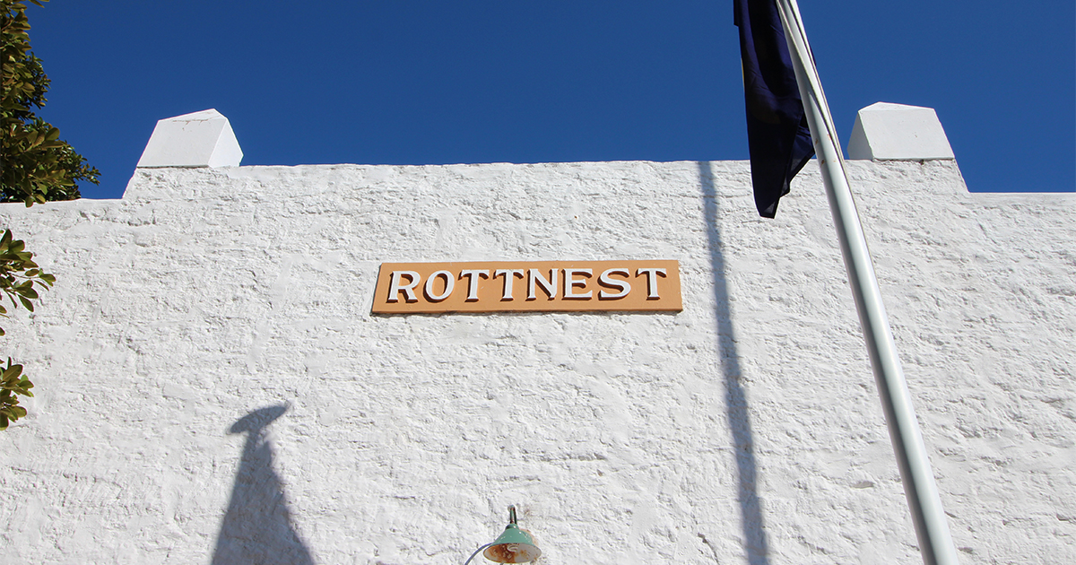 Rottnest Island Lighthouse exterior with a Rottentest sign, supported by DCE backup power systems for reliable power.